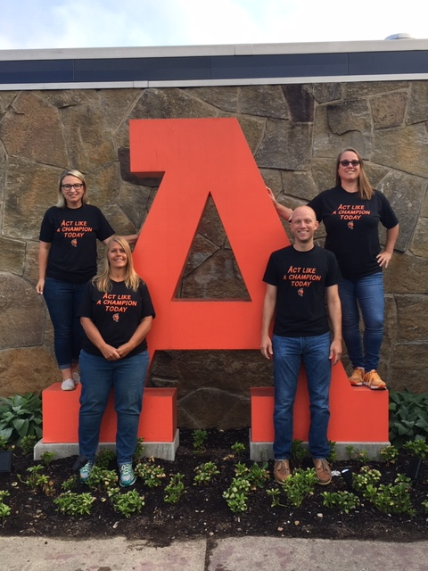 Teachers standing around "A"