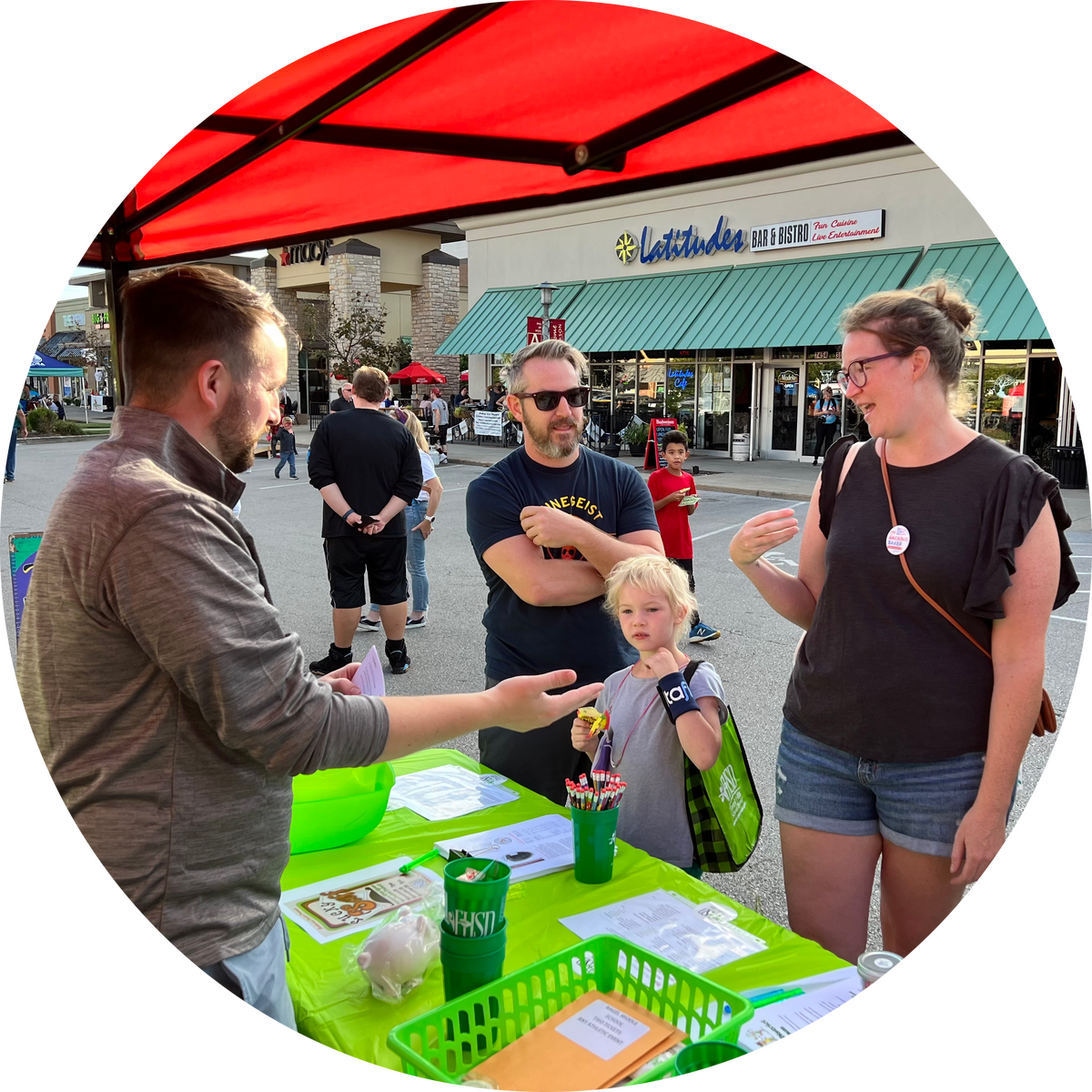 person talking to family at booth