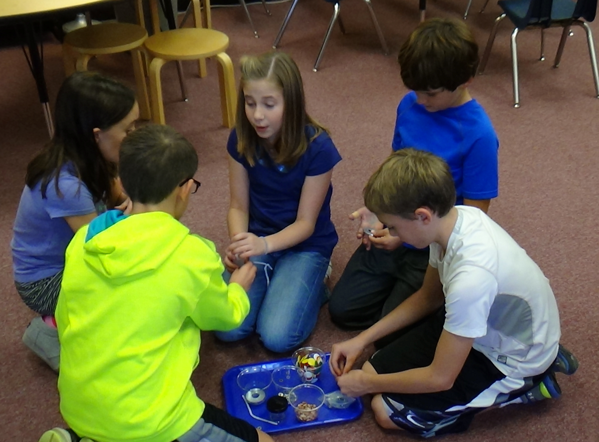 Students working together to build a project in a class room