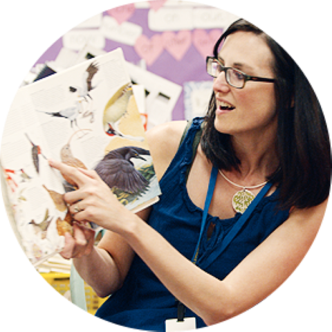 Teacher pointing to a bird in the book they are reading