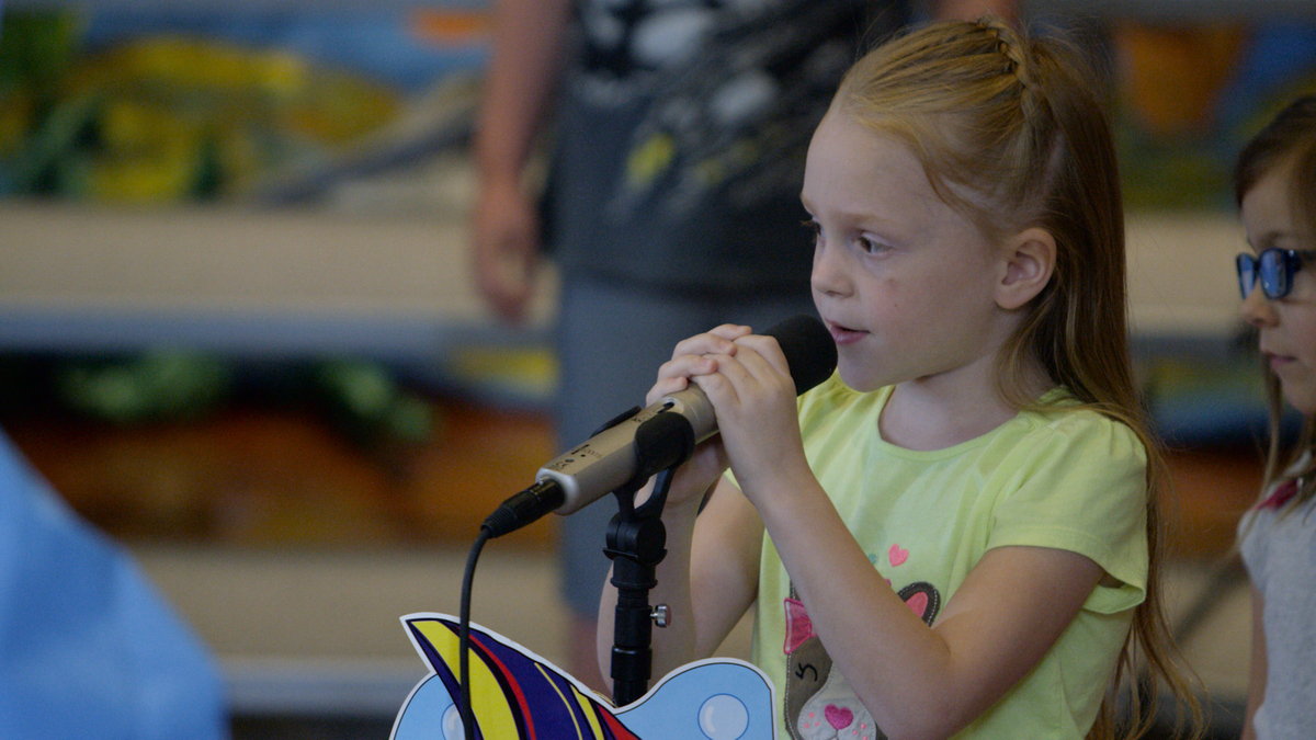 Student speaks into a microphone