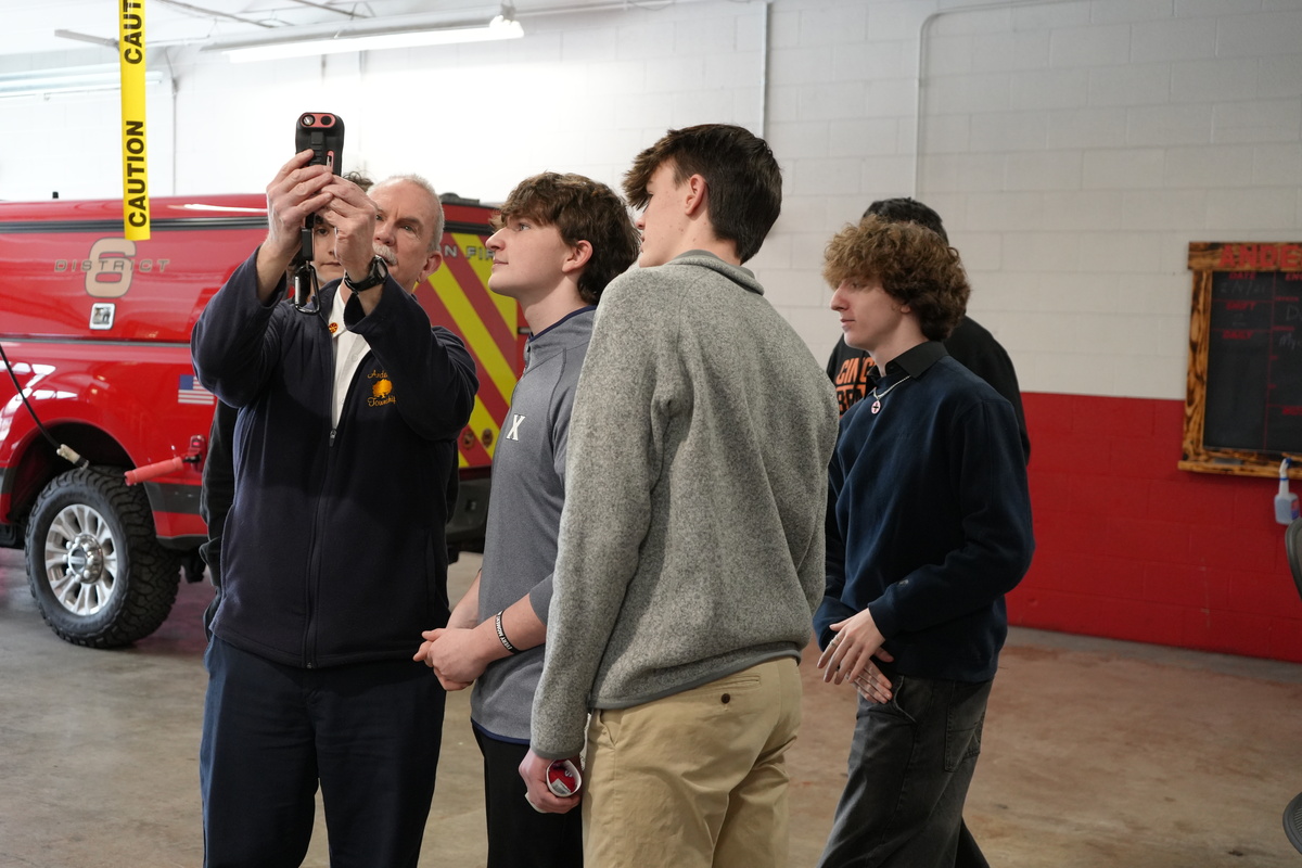 A group of Aspire students learning about a tool at the fire station.