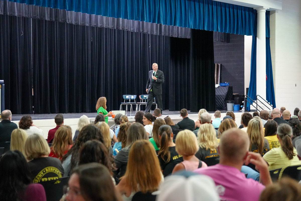 Superintendent Larry Hook speaks on stage in front of all FHSD staff
