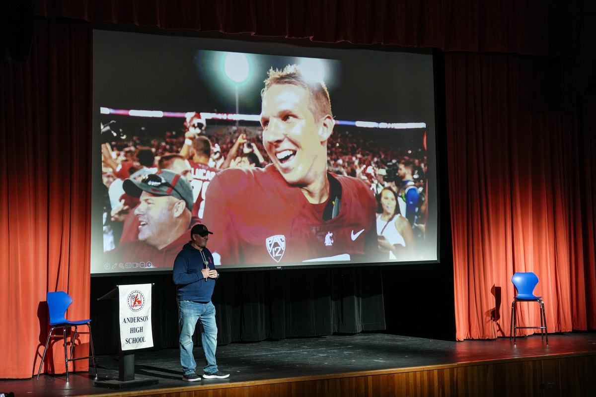 Mark Hilinski stands in front of a photo of his late son Tyler