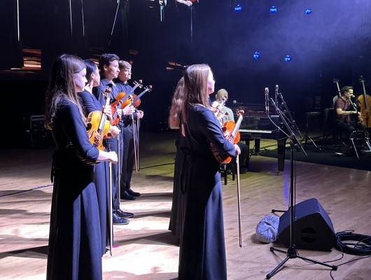 Orchestra students perform on stage