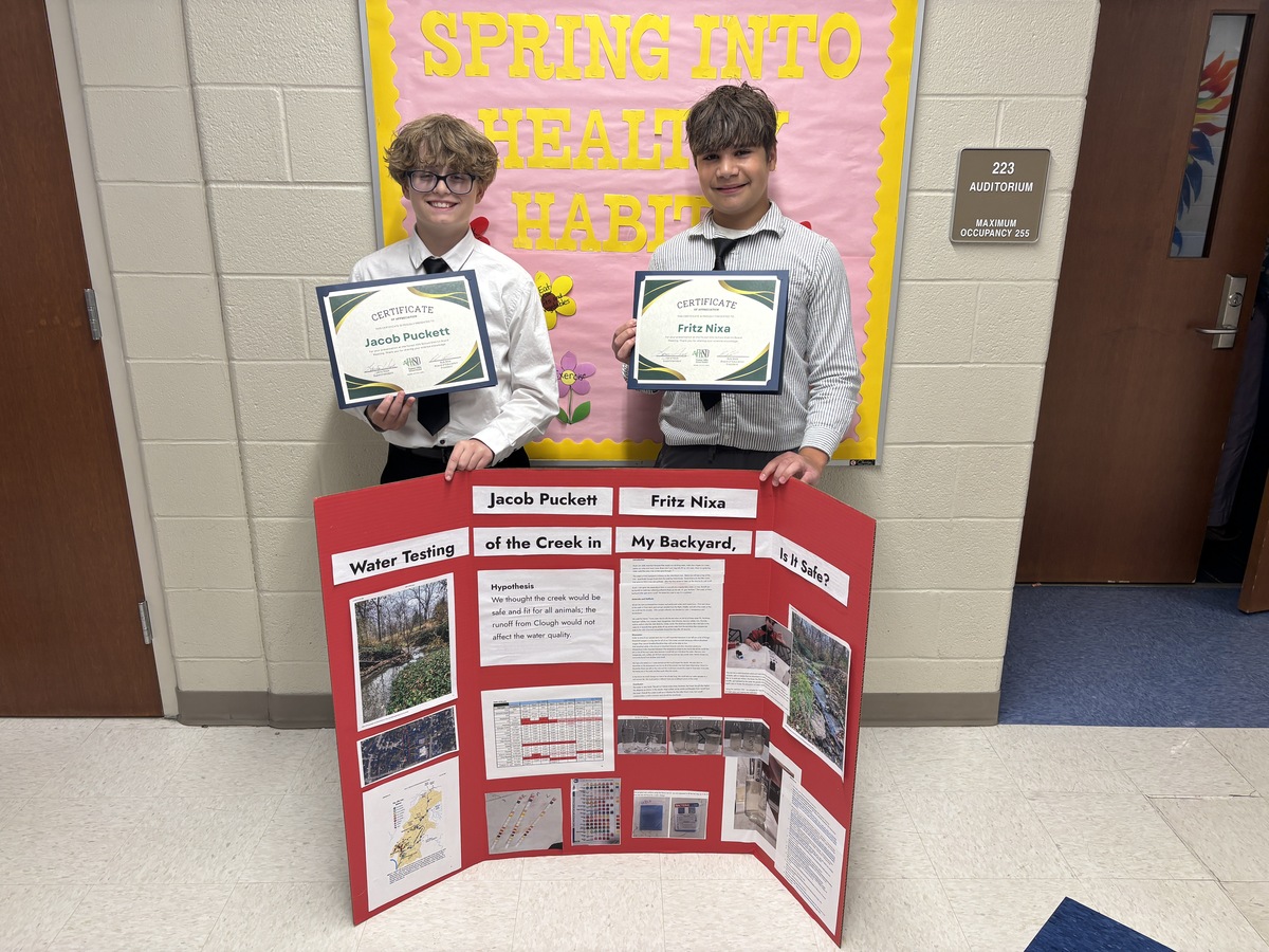 Nagel students pose with certificates of recognition and their science fair project