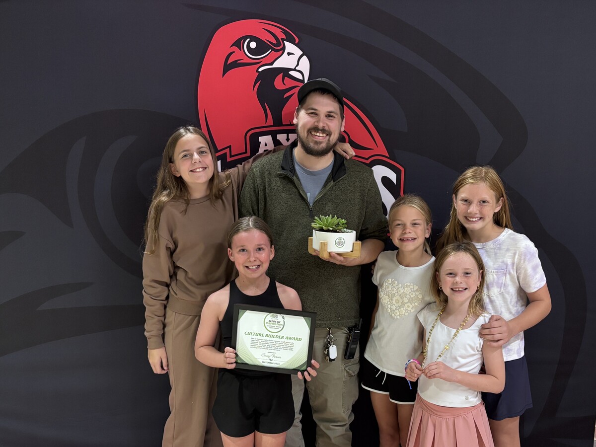 group photo of Mr. Corey and students with his Seeds of Inspiration award