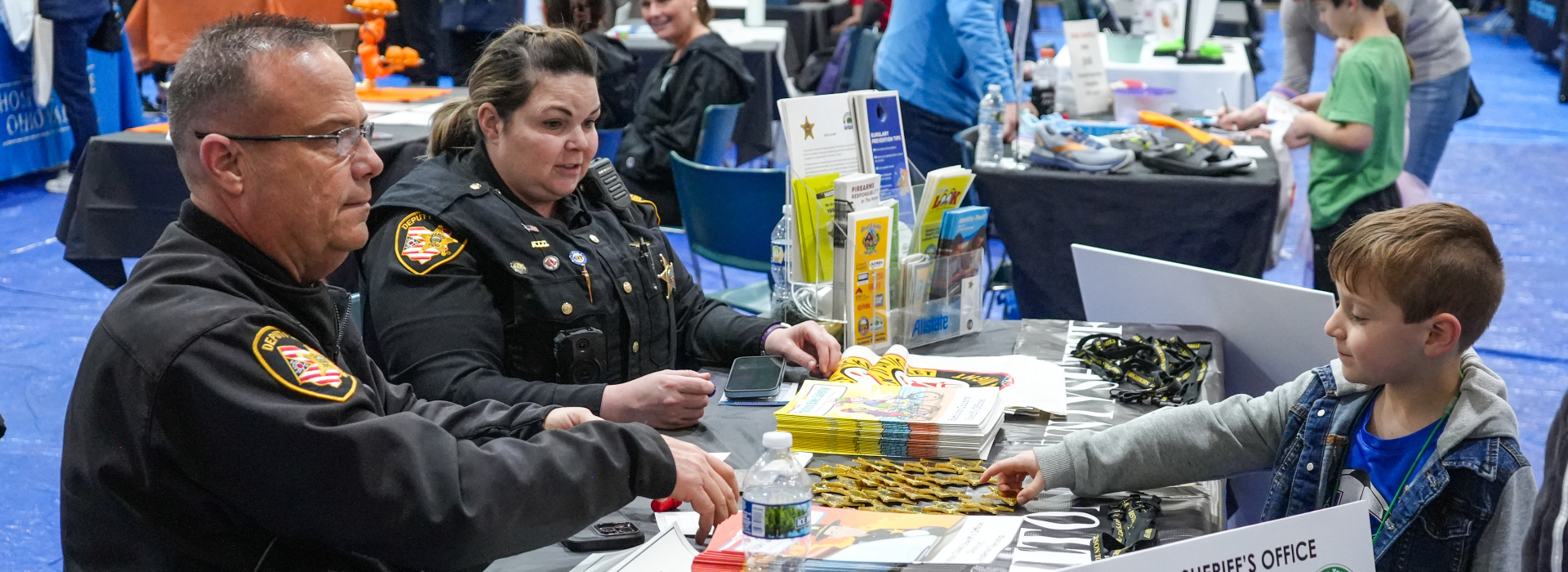 Student learns more about the Sheriff's Office at its booth at the community wellness fair 