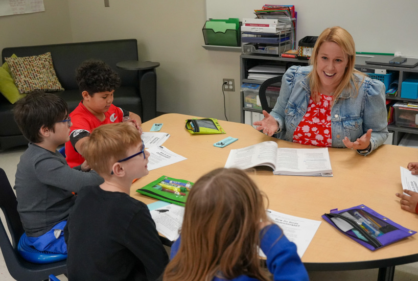 teacher smiles at a student during a lesson