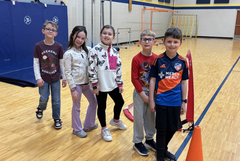 students smile for a photo during PE class