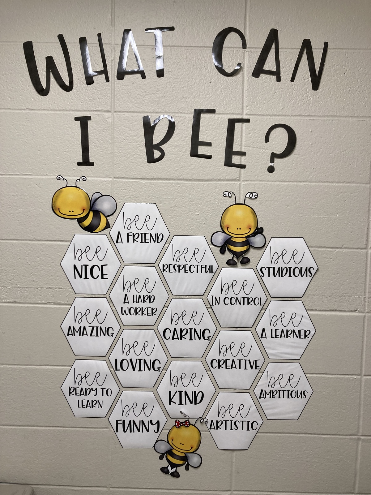 "What Can I Bee" wall with nice word as honeycomb shapes